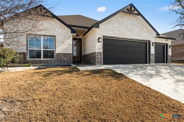 view of front of property with a garage and a front lawn