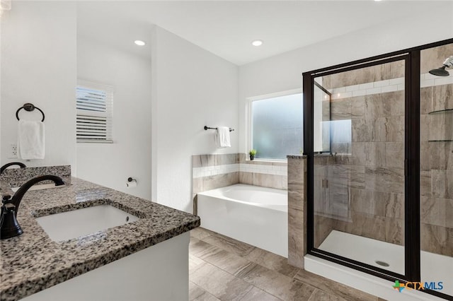 bathroom featuring vanity and plus walk in shower