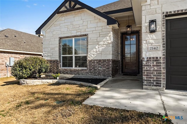 doorway to property with a garage