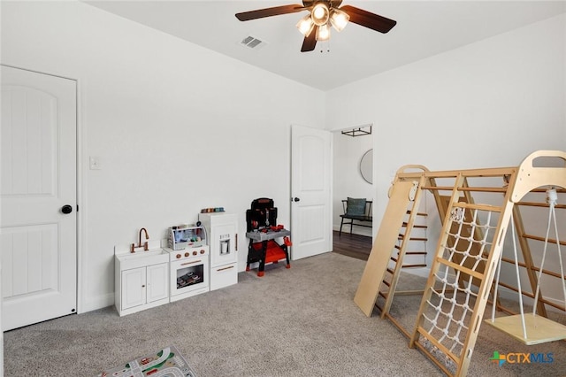 interior space featuring carpet floors and ceiling fan