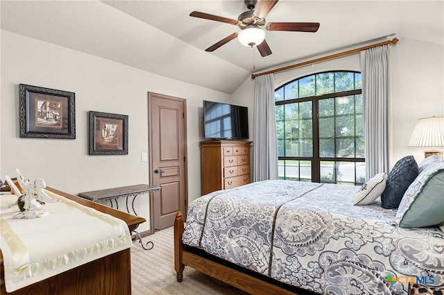 carpeted bedroom with ceiling fan and vaulted ceiling