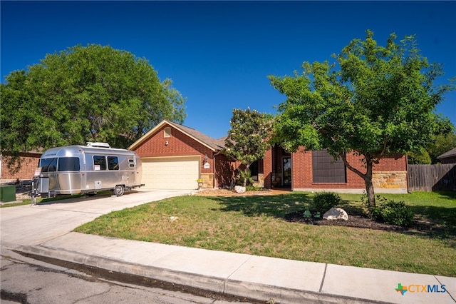 view of front of home with a garage, fence, a front yard, and concrete driveway