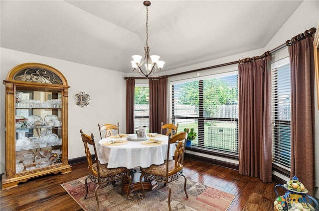 dining room featuring lofted ceiling, baseboards, a chandelier, and dark wood finished floors