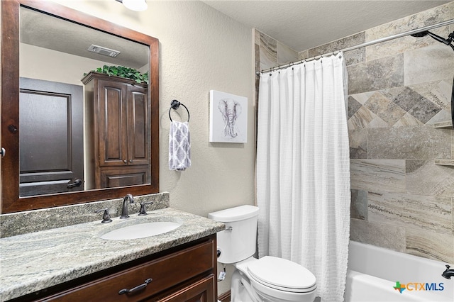 full bath with toilet, a textured wall, vanity, visible vents, and shower / tub combo with curtain