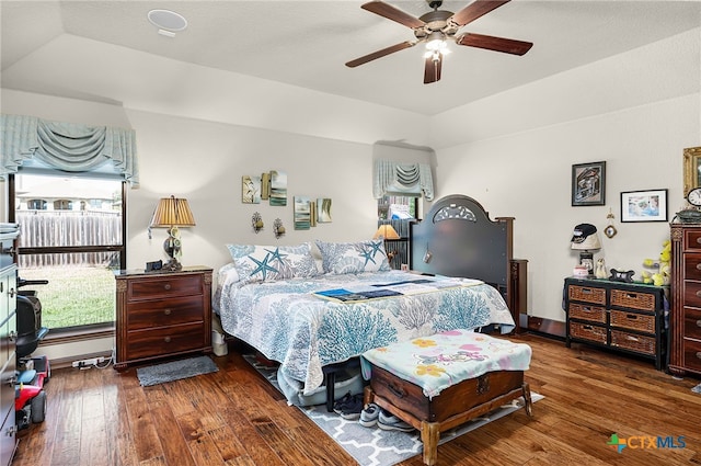 bedroom with multiple windows, ceiling fan, and hardwood / wood-style floors
