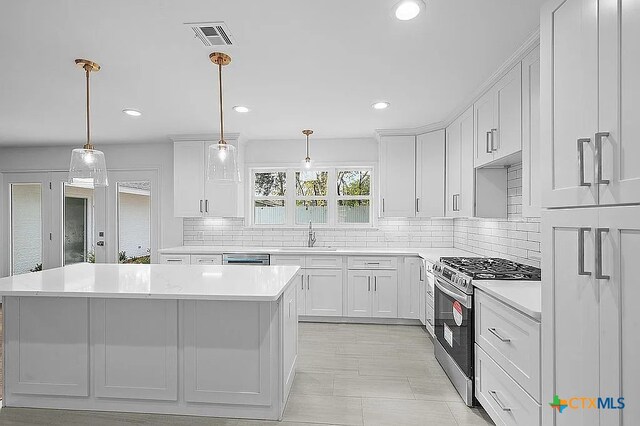 kitchen featuring light countertops, a center island, visible vents, and stainless steel appliances