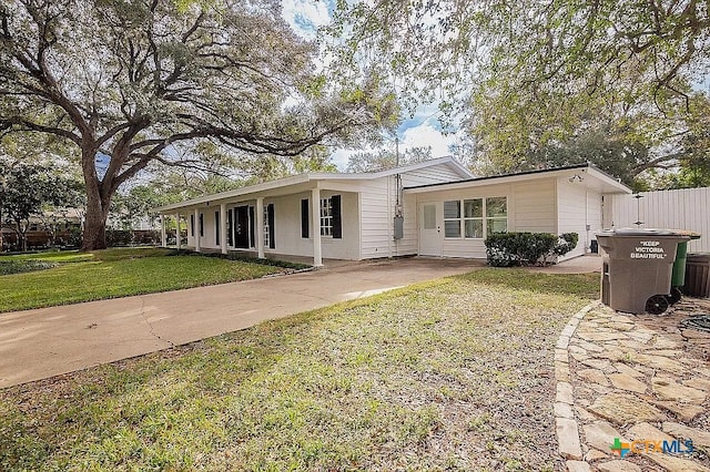 view of front of home with a front lawn and fence