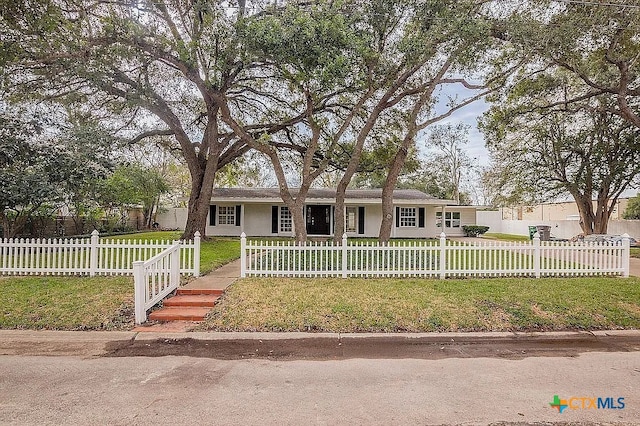 ranch-style house with a front yard and a fenced front yard