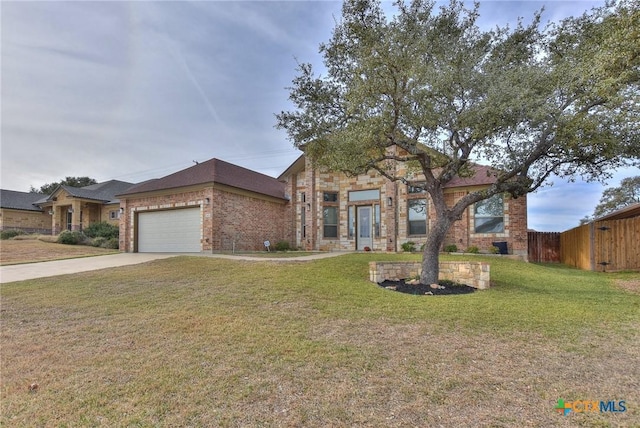 view of front of property featuring a garage and a front yard