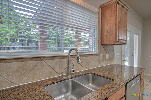 117 Lone Shadow Dr, Harker Heights, TX 76548 - kitchen featuring a sink, dishwasher, decorative backsplash, dark stone countertops, and brown cabinets