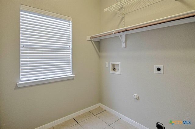 117 Lone Shadow Dr, Harker Heights, TX 76548 - laundry room featuring gas dryer hookup, washer hookup, light tile patterned floors, baseboards, and electric dryer hookup