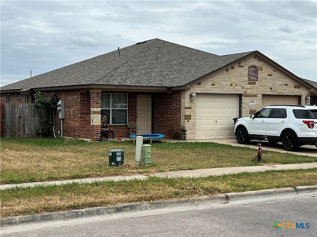 view of front of house with a garage and a front yard