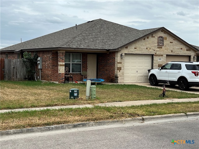 view of front of home featuring a garage and a front yard