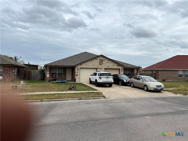 view of front of home featuring a garage and a front yard