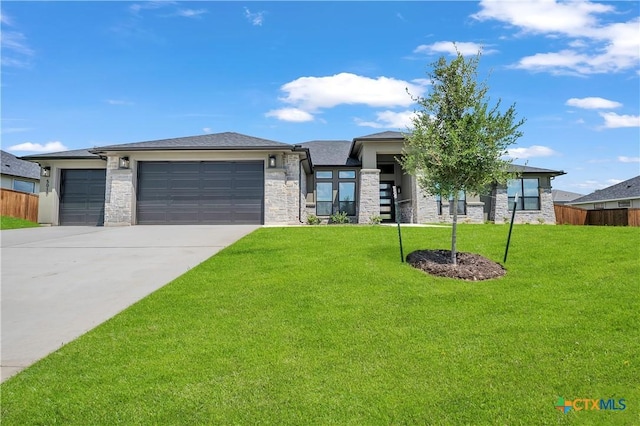 prairie-style house with a front yard and a garage