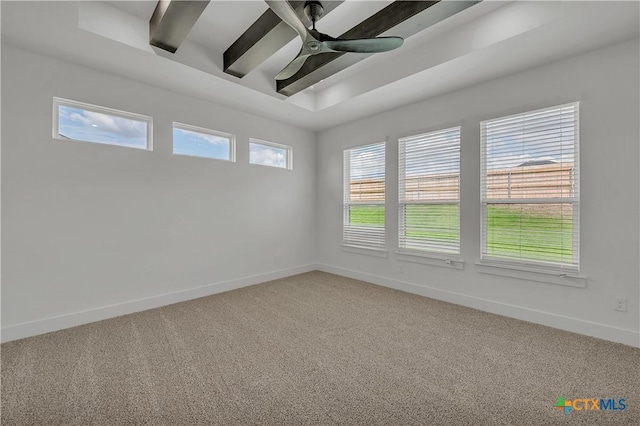 carpeted empty room with beamed ceiling and ceiling fan