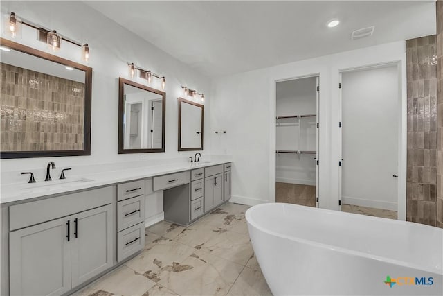 bathroom featuring a bathing tub and vanity