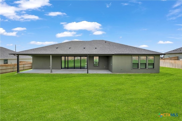 rear view of property with a patio area and a yard