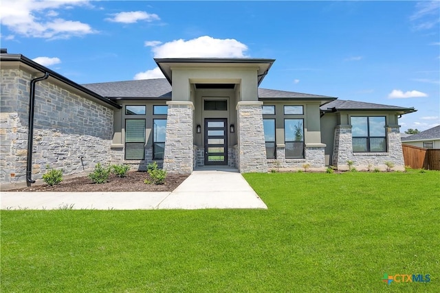 view of exterior entry with a yard