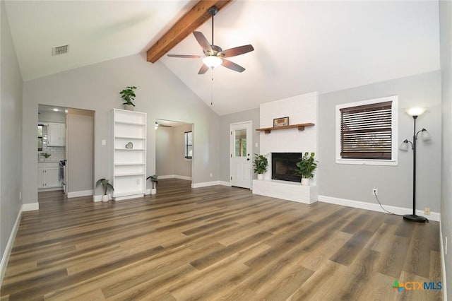 unfurnished living room with ceiling fan, beamed ceiling, and dark hardwood / wood-style floors