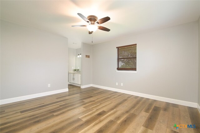 empty room with ceiling fan and wood-type flooring