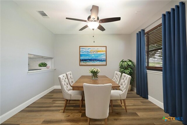 dining room featuring dark hardwood / wood-style floors and ceiling fan