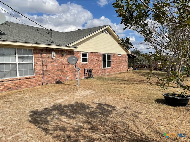 view of side of home featuring a yard