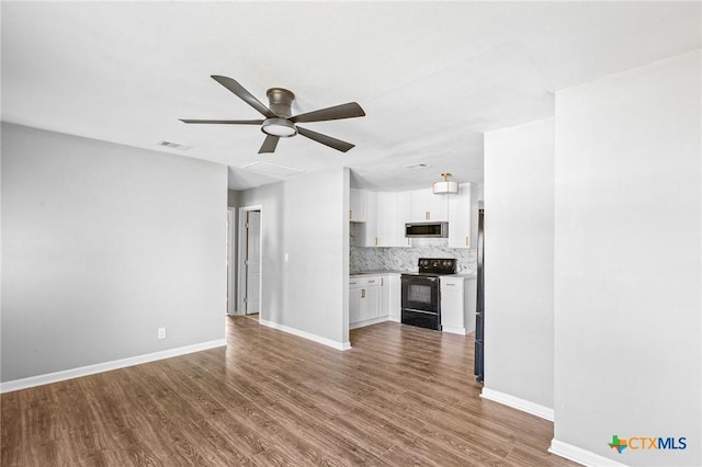 unfurnished living room featuring baseboards, a ceiling fan, visible vents, and dark wood finished floors