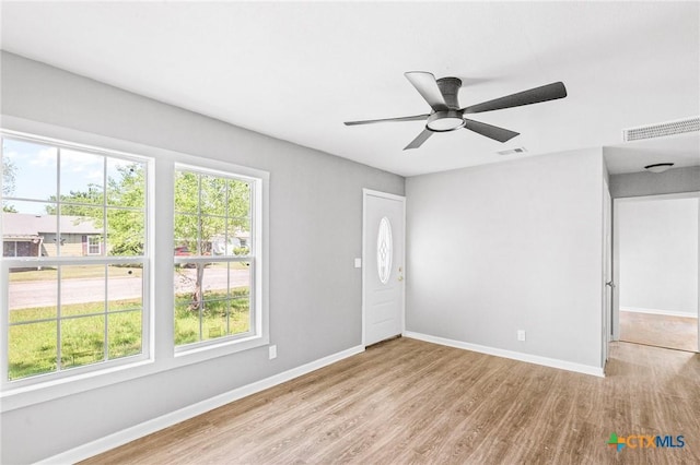 interior space with wood finished floors, visible vents, and a wealth of natural light