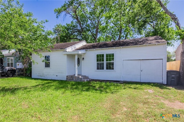 ranch-style home with a front lawn and a garage