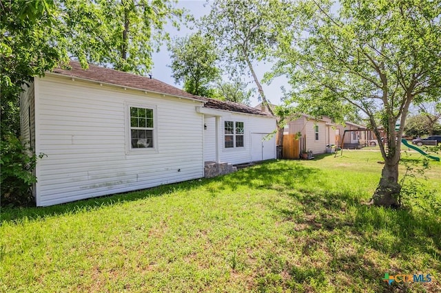 rear view of house featuring a yard