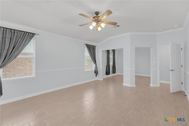 spare room featuring crown molding, baseboards, visible vents, and ceiling fan