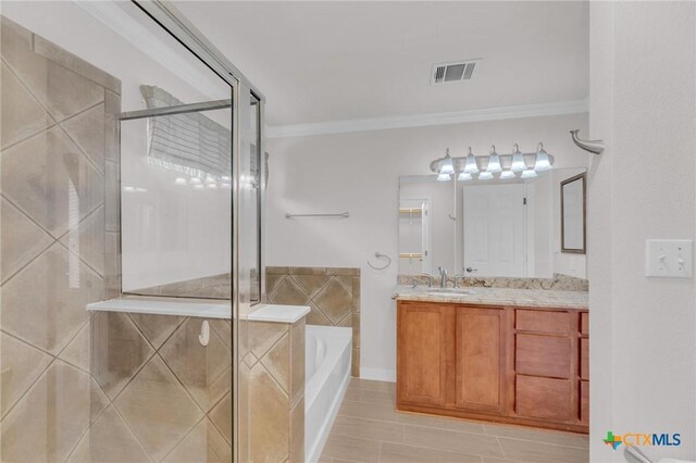 bathroom featuring a bath, a shower stall, vanity, and ornamental molding