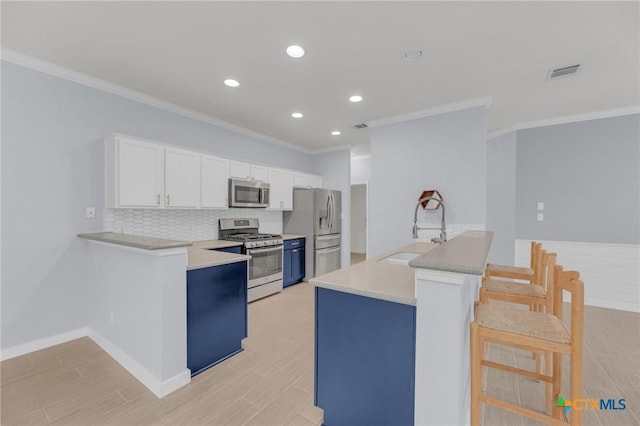 kitchen with white cabinetry, visible vents, appliances with stainless steel finishes, and a sink