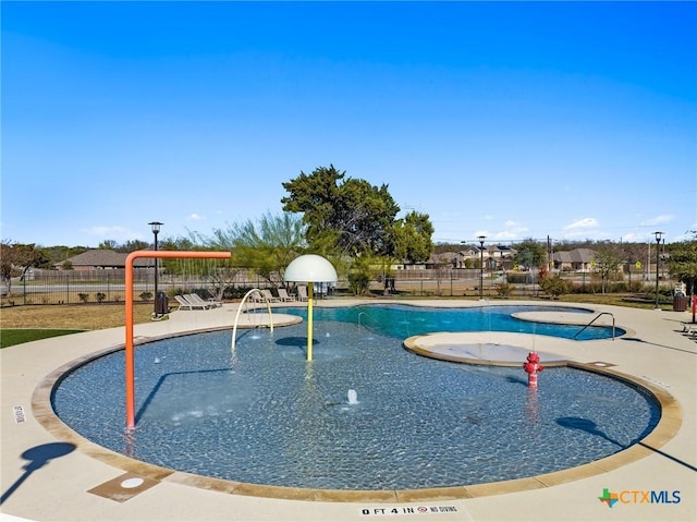 view of pool featuring fence