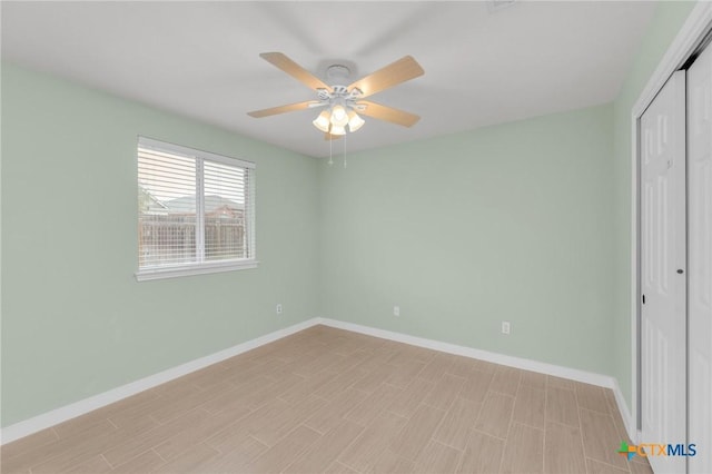 unfurnished bedroom featuring a closet, ceiling fan, light wood finished floors, and baseboards