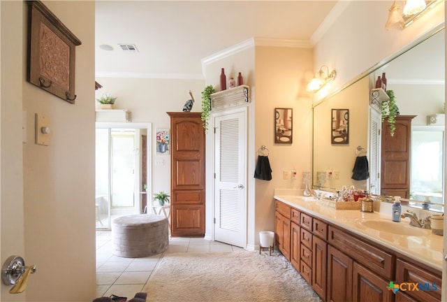 bathroom featuring vanity, tile patterned floors, and crown molding