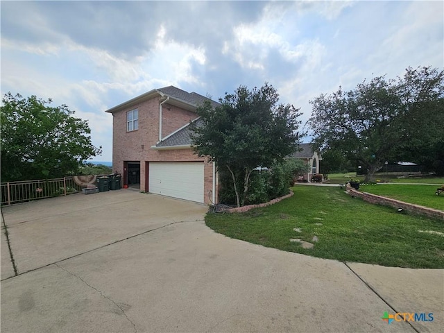 719 Walnut Dr, Killeen, TX 76549 - view of side of property featuring concrete driveway, a garage, a yard, and brick siding