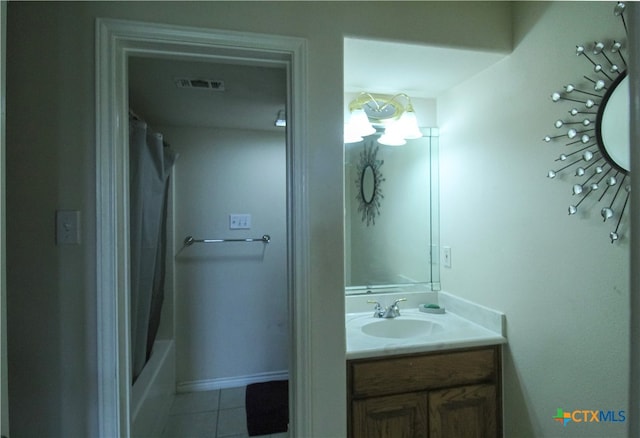 bathroom featuring vanity, tile patterned floors, and shower / bath combo with shower curtain