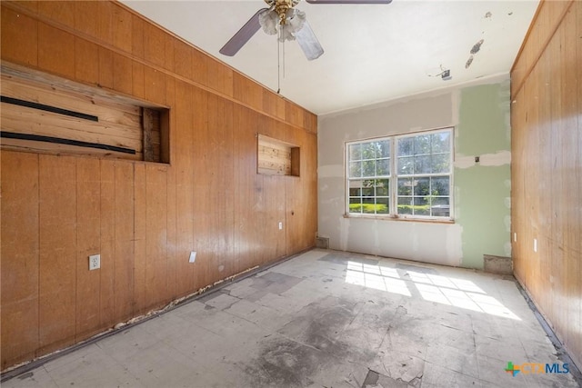 1303 N W S Young Dr, Killeen, TX 76543 - empty room featuring wood walls and a ceiling fan