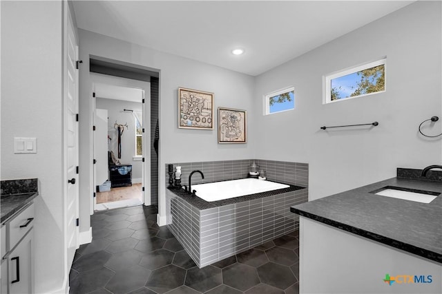 123 Wandering Oak Cir, Burnet, TX 78611 - bathroom with vanity, tile patterned flooring, a garden tub, baseboards, and recessed lighting