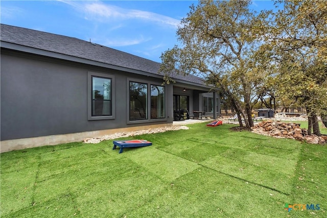 123 Wandering Oak Cir, Burnet, TX 78611 - rear view of house with a yard and roof with shingles