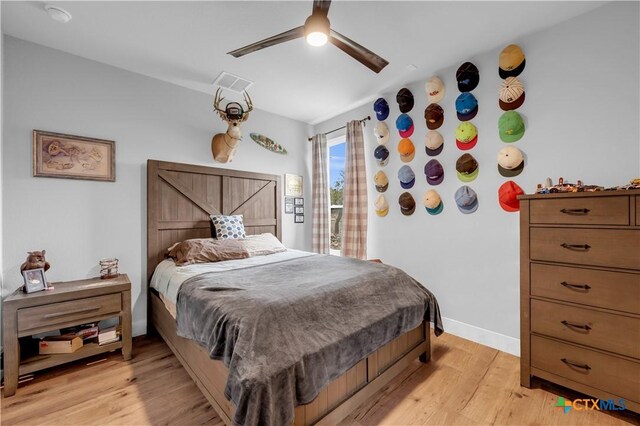 123 Wandering Oak Cir, Burnet, TX 78611 - bedroom featuring light wood-type flooring, a ceiling fan, baseboards, and access to exterior