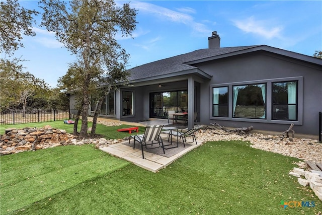 123 Wandering Oak Cir, Burnet, TX 78611 - back of house featuring a patio, stucco siding, a chimney, and a shingled roof