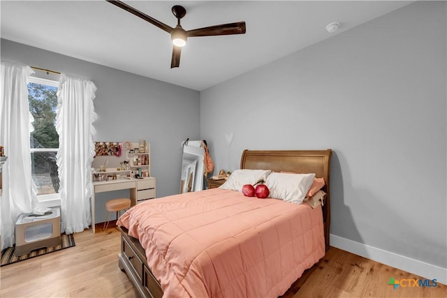 123 Wandering Oak Cir, Burnet, TX 78611 - bedroom with light wood-style flooring, a ceiling fan, and baseboards