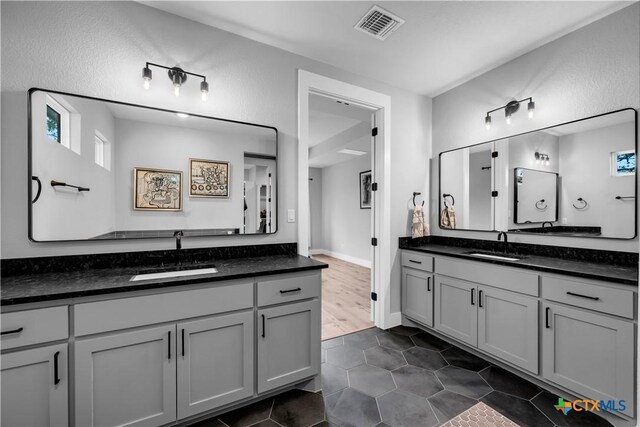 123 Wandering Oak Cir, Burnet, TX 78611 - full bath with two vanities and tile patterned flooring