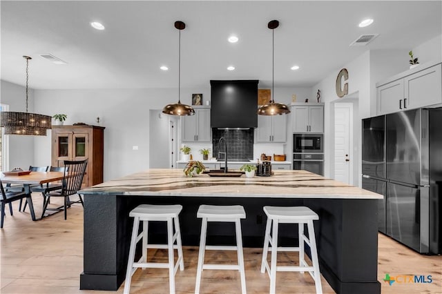 123 Wandering Oak Cir, Burnet, TX 78611 - kitchen with freestanding refrigerator, wall oven, black microwave, tasteful backsplash, and a spacious island