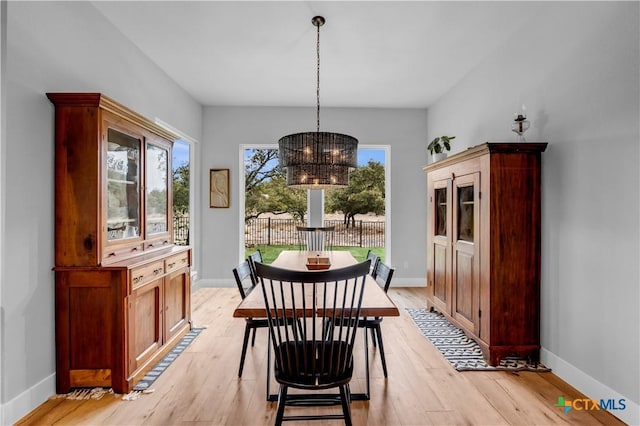 123 Wandering Oak Cir, Burnet, TX 78611 - dining area with light wood-type flooring, a chandelier, and baseboards