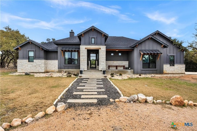 123 Wandering Oak Cir, Burnet, TX 78611 - view of front of home with board and batten siding, stone siding, a shingled roof, a front lawn, and a chimney