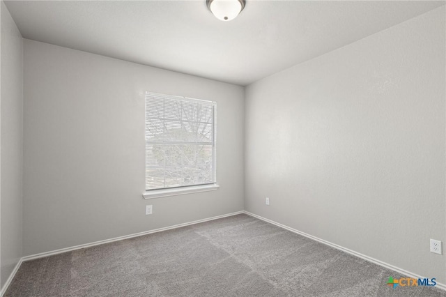 carpeted spare room with baseboards